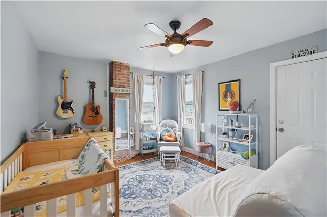 a bedroom with a bed wooden floor and a window