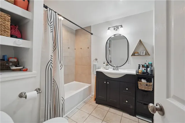 a bathroom with a sink vanity mirror and toilet