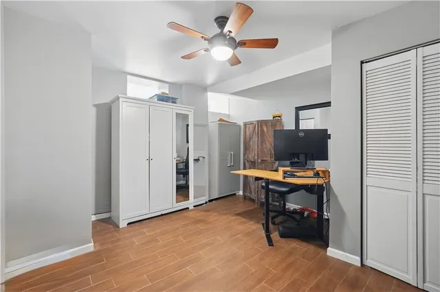 a view of a workspace with furniture and a window