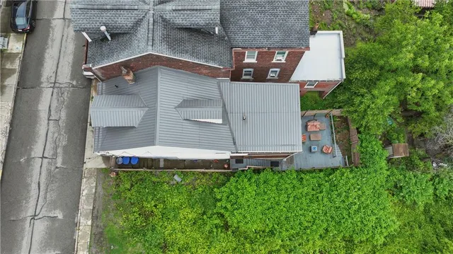 a aerial view of a house with a yard and table and chairs