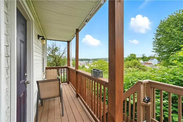 a view of a balcony with wooden floor