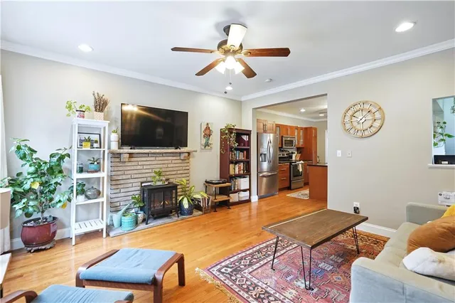 a living room with furniture a fireplace and a flat screen tv