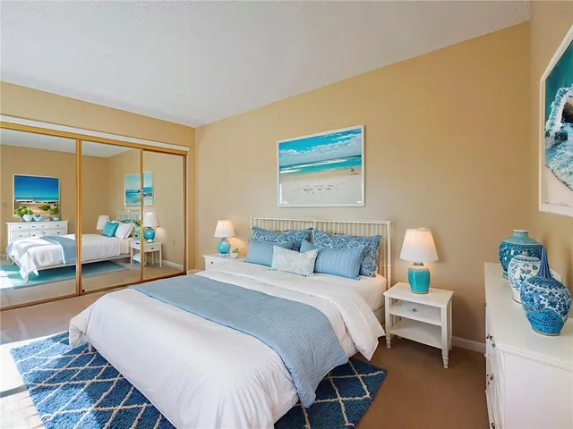 a bedroom with bed and a couch