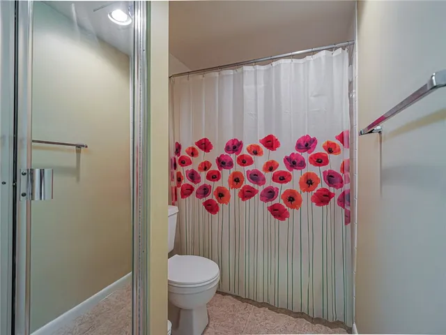 a bathroom with a toilet and a shower