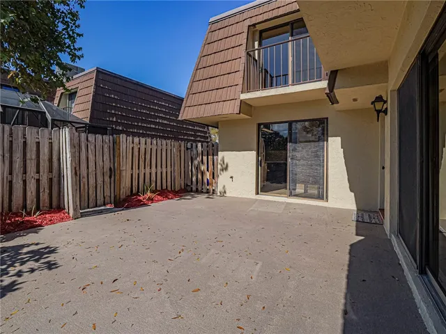 a view of a house with wooden fence