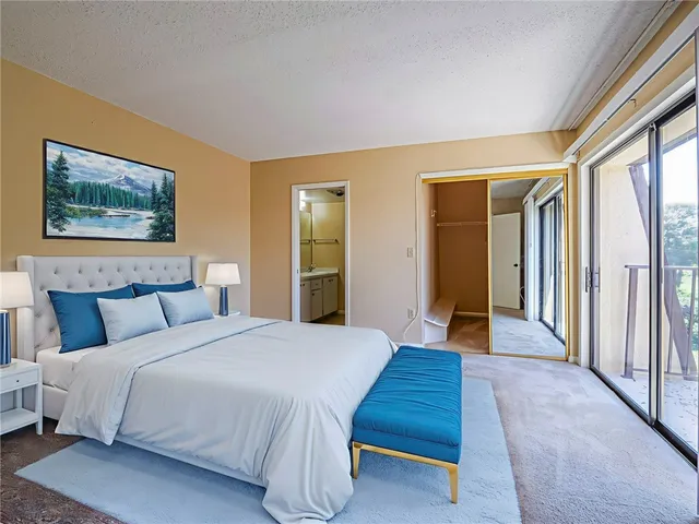 a spacious bedroom with a bed and a large window