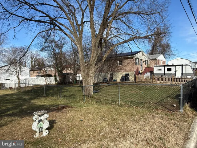 a backyard of a house with lots of green space and fountain