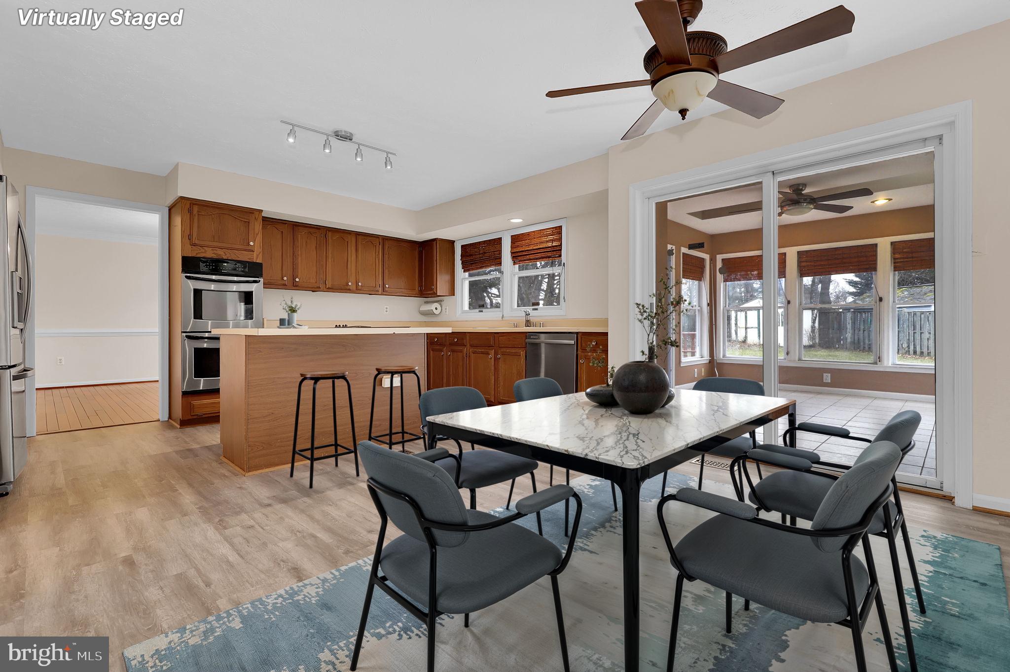 13404 Bregman Road Silver Spring, MD 20904 - Photo 25 of 53 a view of a dining room with furniture and a chandelier