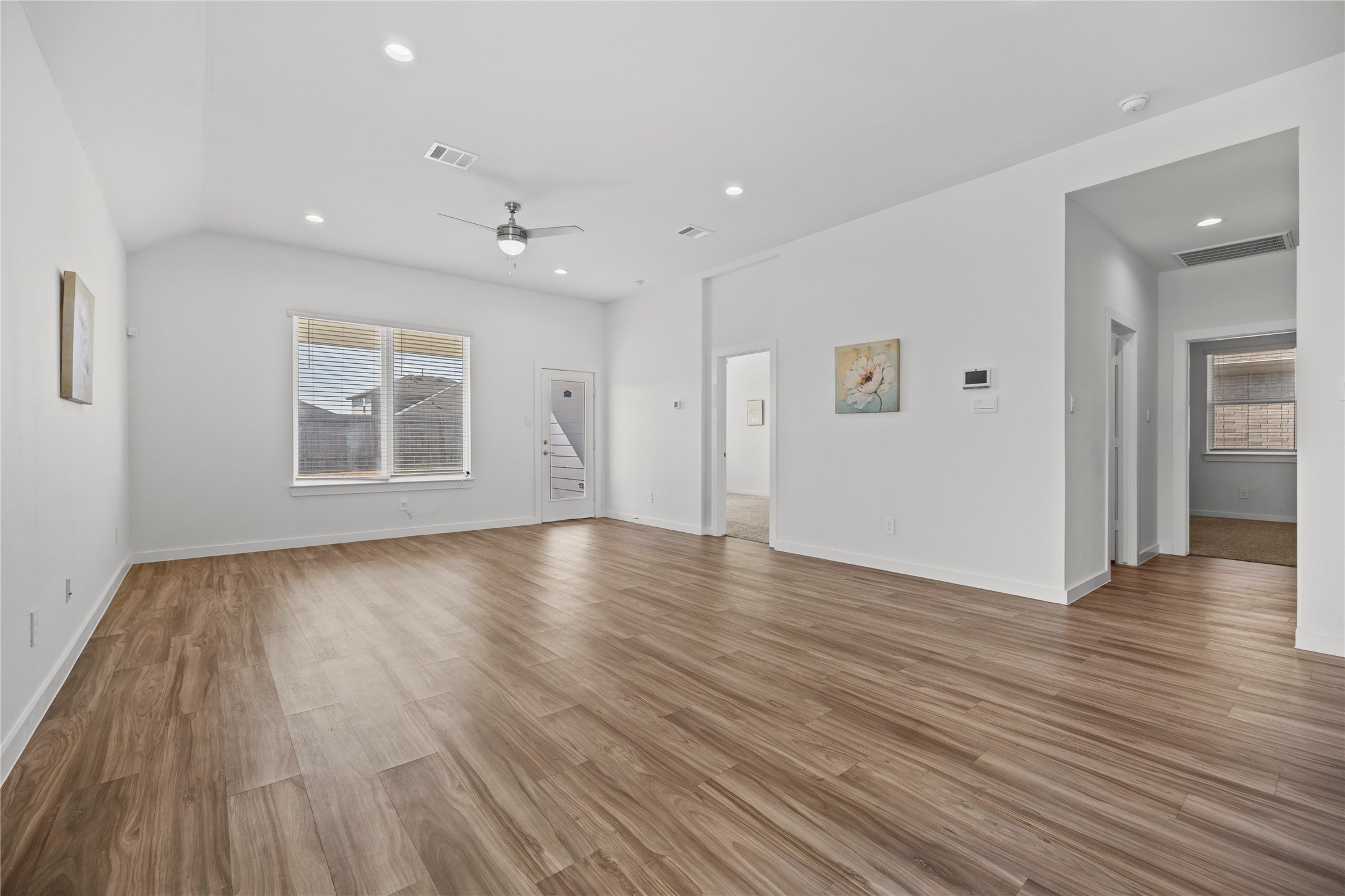 22803 Modica Rift Lane Katy, TX 77449 - Photo 11 of 30 a view of an empty room with wooden floor and a window