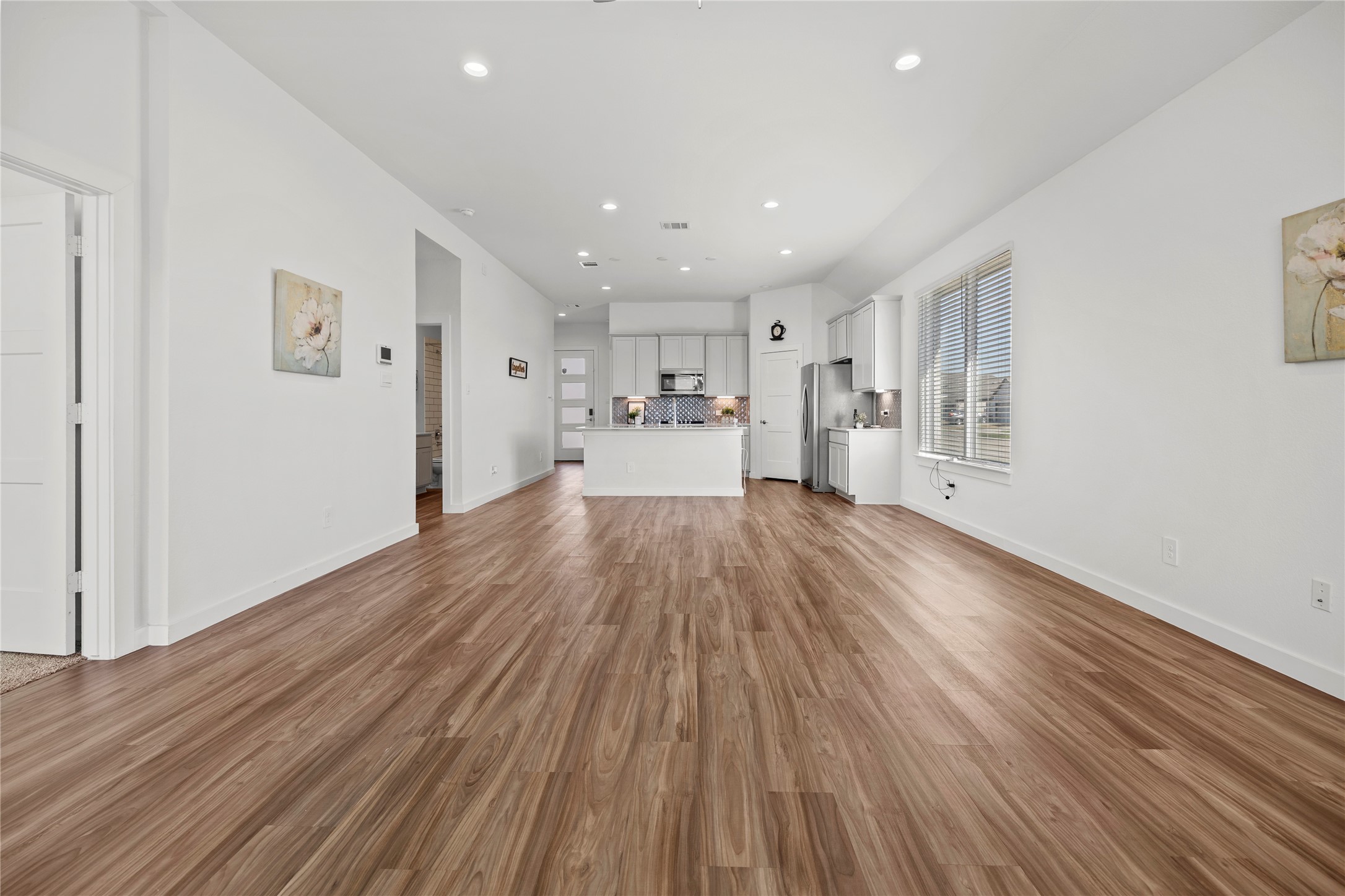 22803 Modica Rift Lane Katy, TX 77449 - Photo 13 of 30 a view of a big room with wooden floor and windows