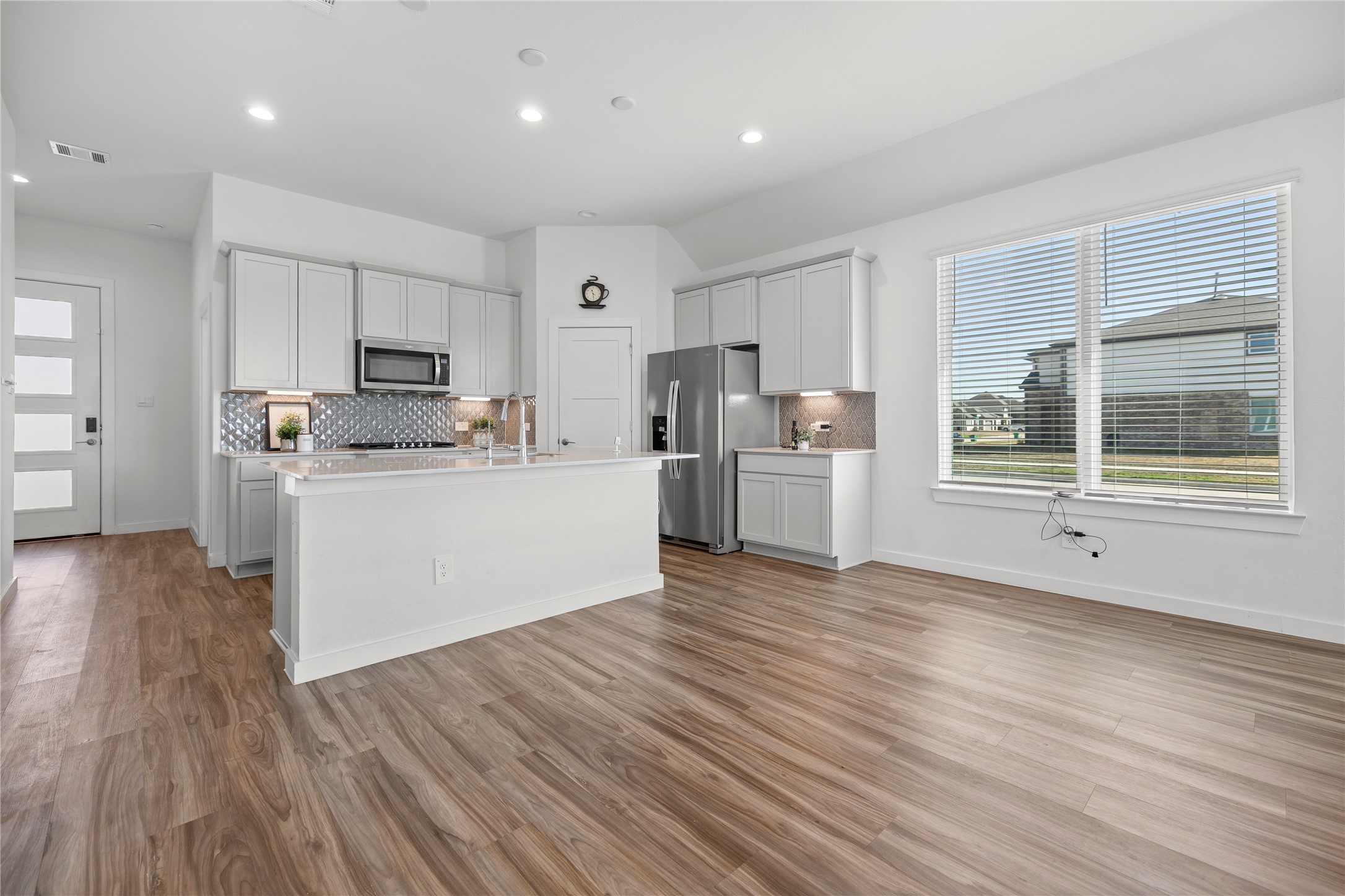 22803 Modica Rift Lane Katy, TX 77449 - Photo 15 of 30 a view of a kitchen with a sink wooden cabinets and stainless steel appliances