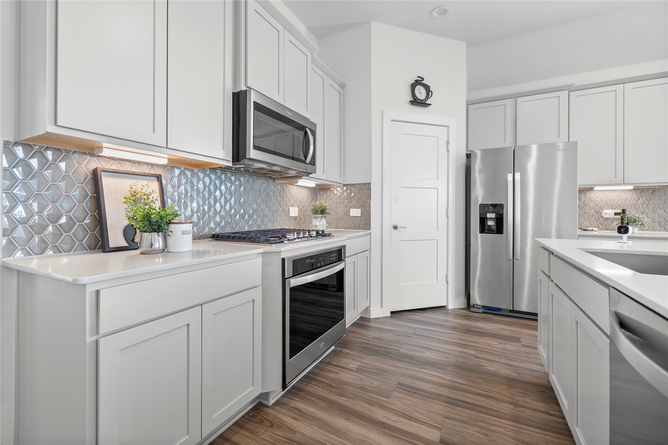 22803 Modica Rift Lane Katy, TX 77449 - Photo 16 of 30 a kitchen with white cabinets stainless steel appliances and a sink