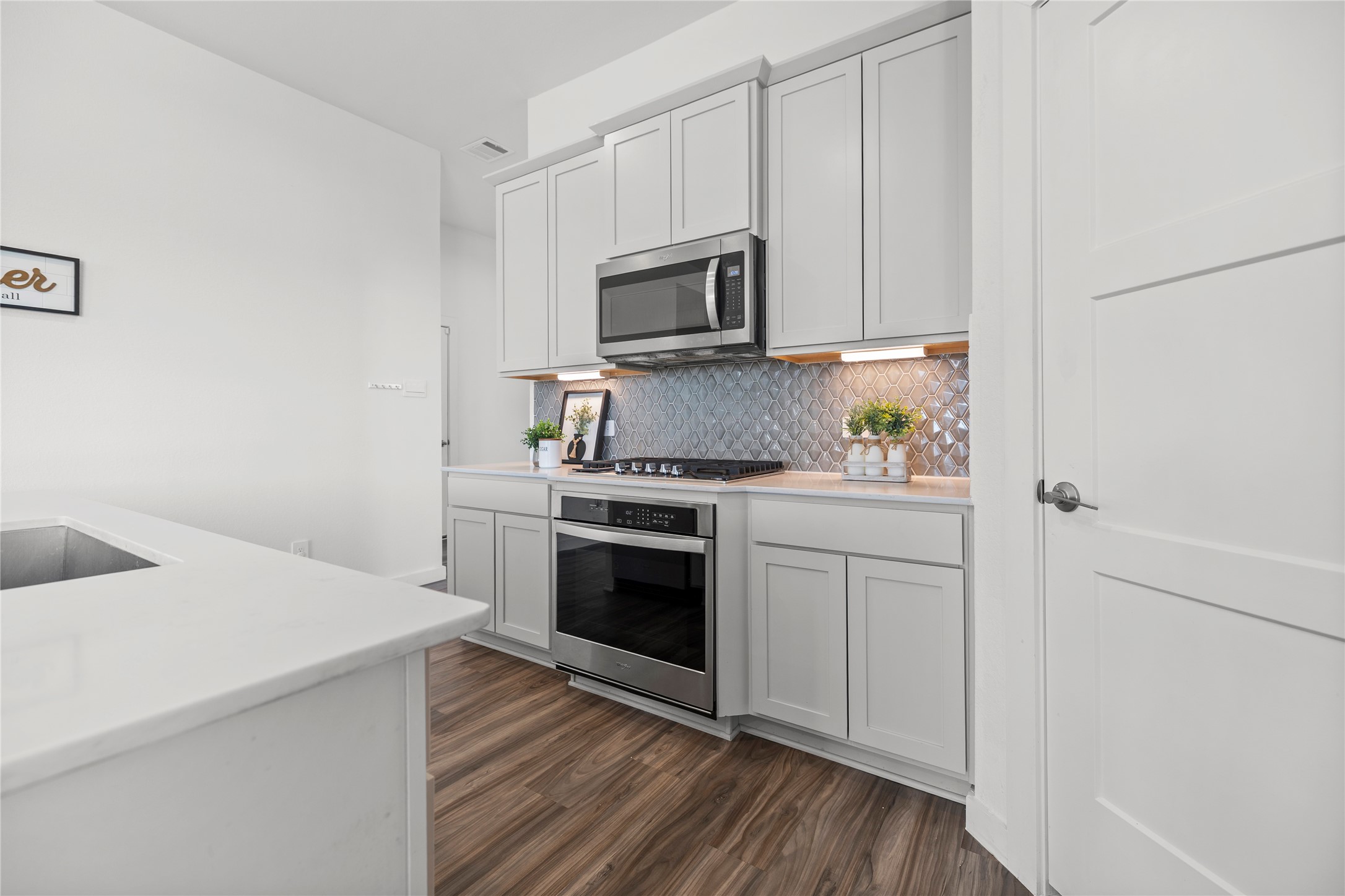 22803 Modica Rift Lane Katy, TX 77449 - Photo 17 of 30 a kitchen with a sink cabinets and stainless steel appliances