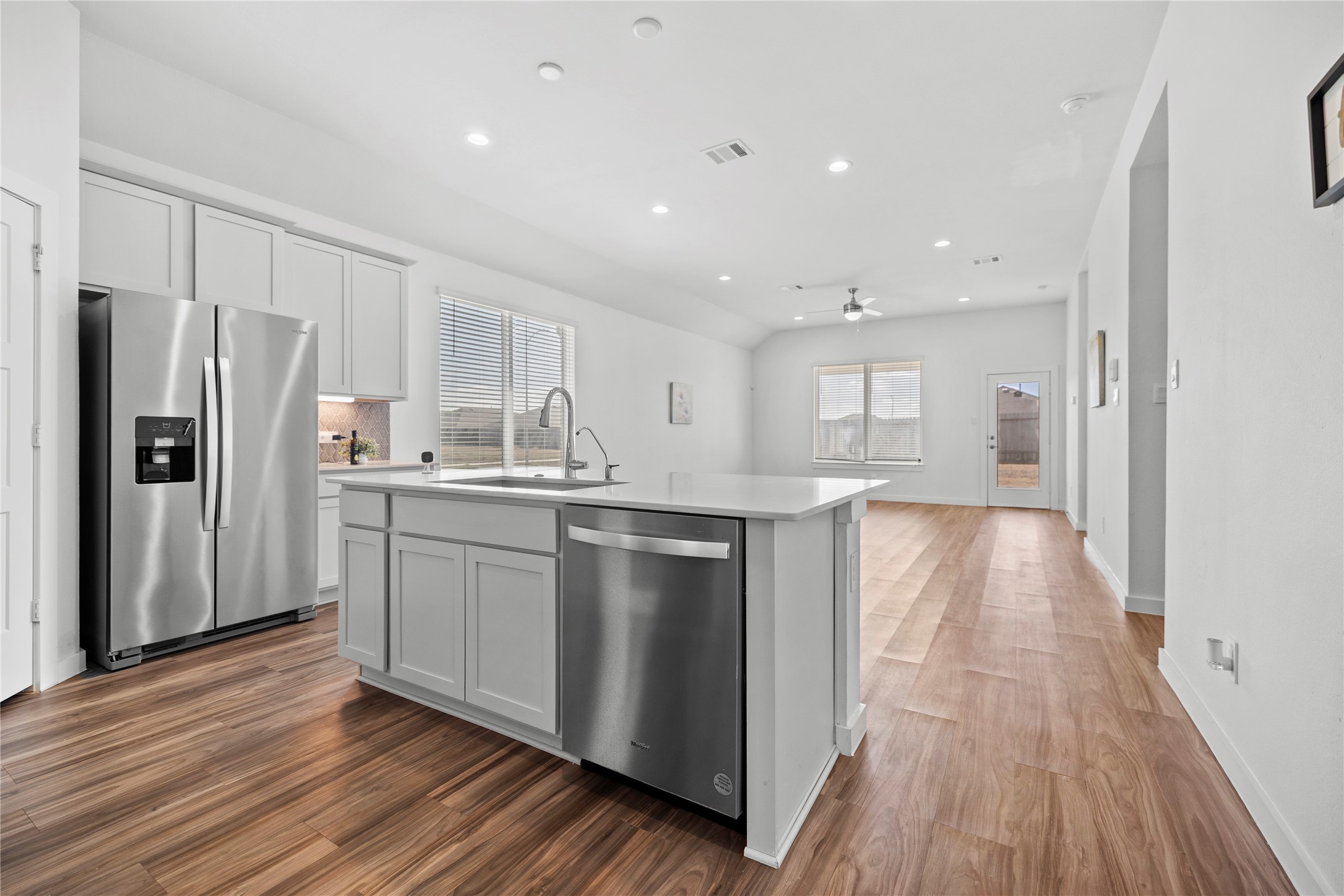 22803 Modica Rift Lane Katy, TX 77449 - Photo 9 of 30 a kitchen with stainless steel appliances a refrigerator and wooden floor