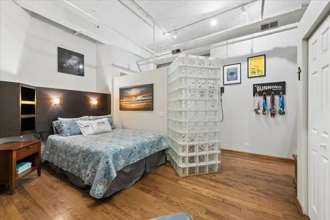 a bedroom with a bed and a lamp on the table