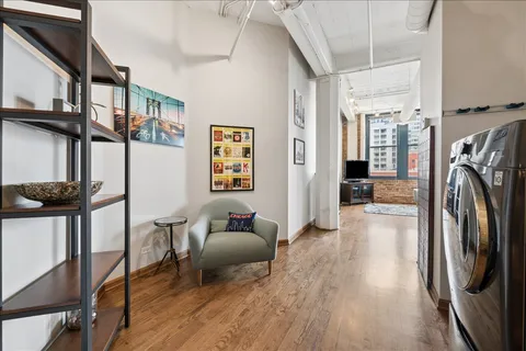 a view of a hallway with wooden floor and furniture