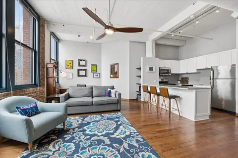 a living room with furniture and kitchen view