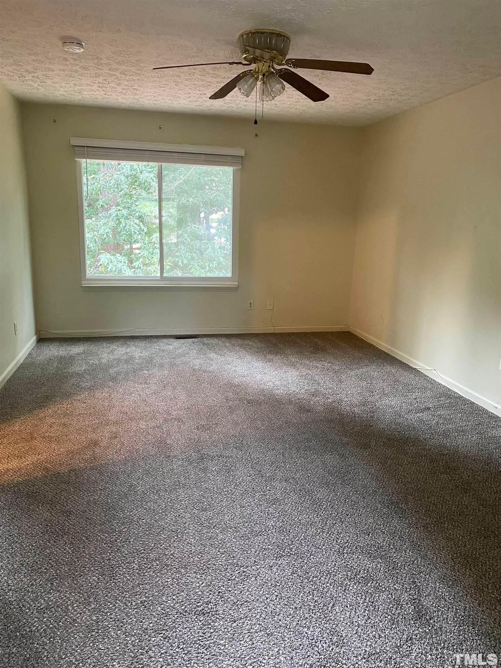 2801 Henslowe Drive Raleigh, NC 27603 - Photo 13 of 17 an empty room with windows and chandelier fan