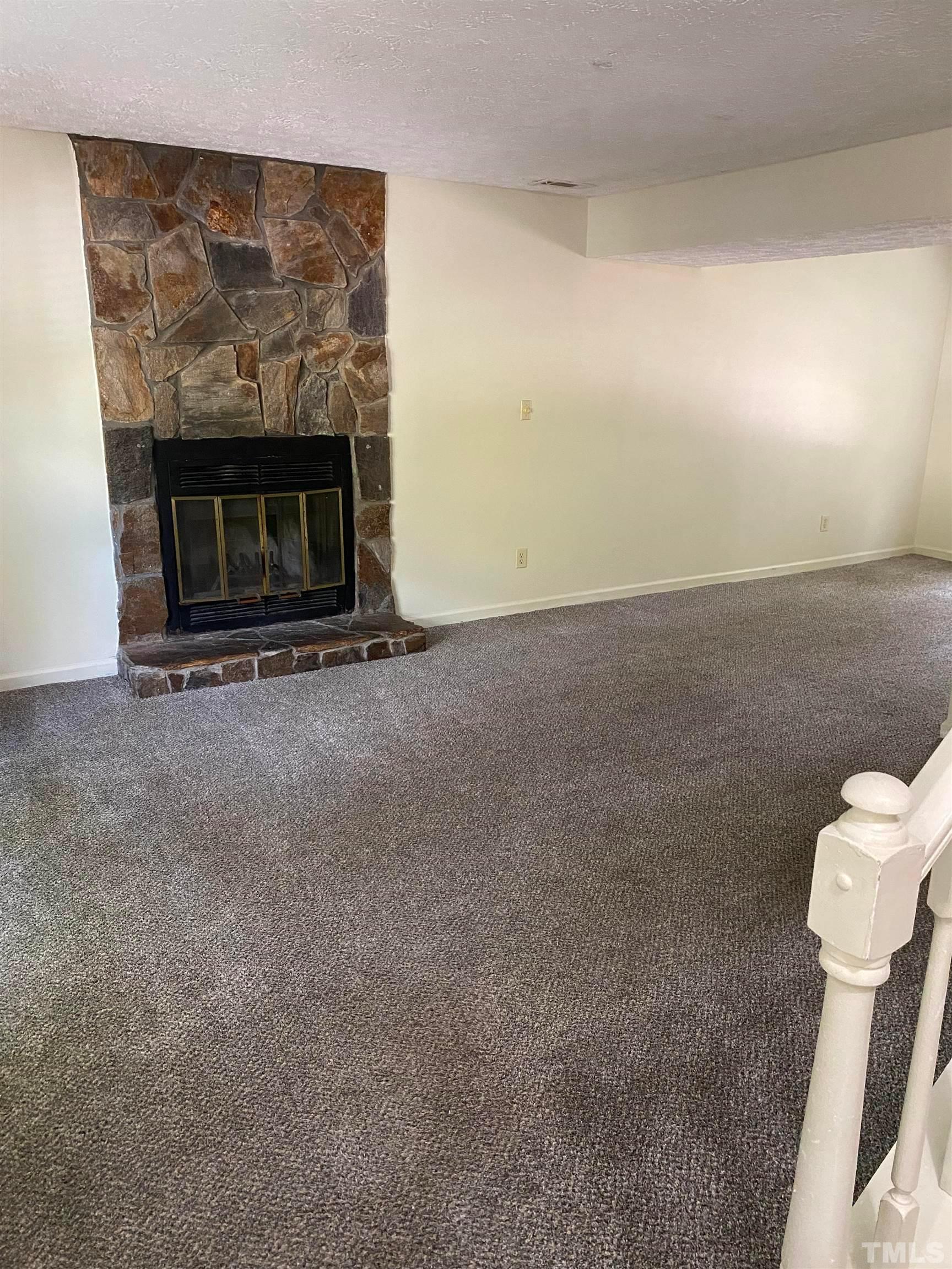 2801 Henslowe Drive Raleigh, NC 27603 - Photo 2 of 17 a living room with furniture and a fireplace