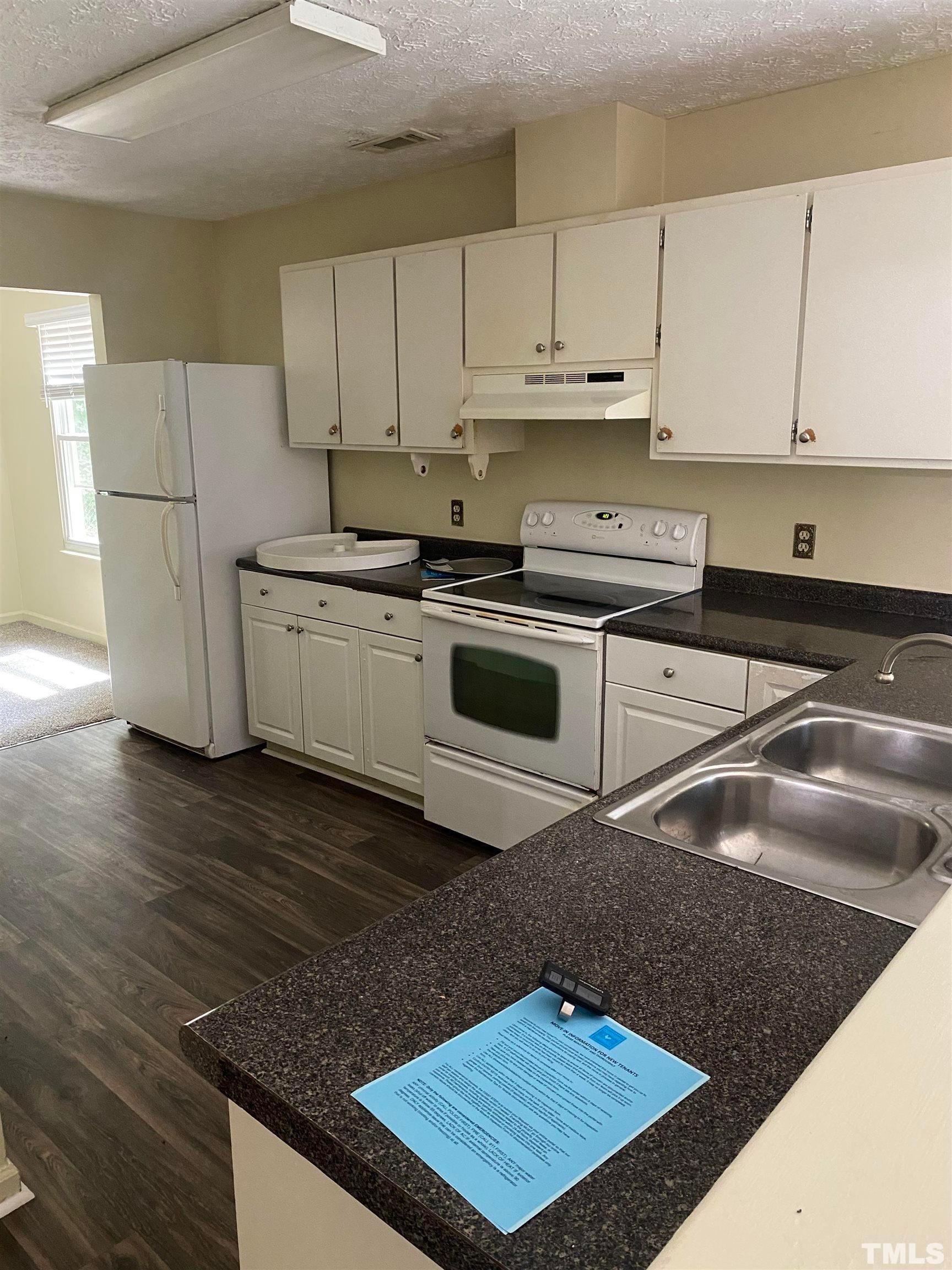 2801 Henslowe Drive Raleigh, NC 27603 - Photo 7 of 17 a kitchen with a sink cabinets and stainless steel appliances