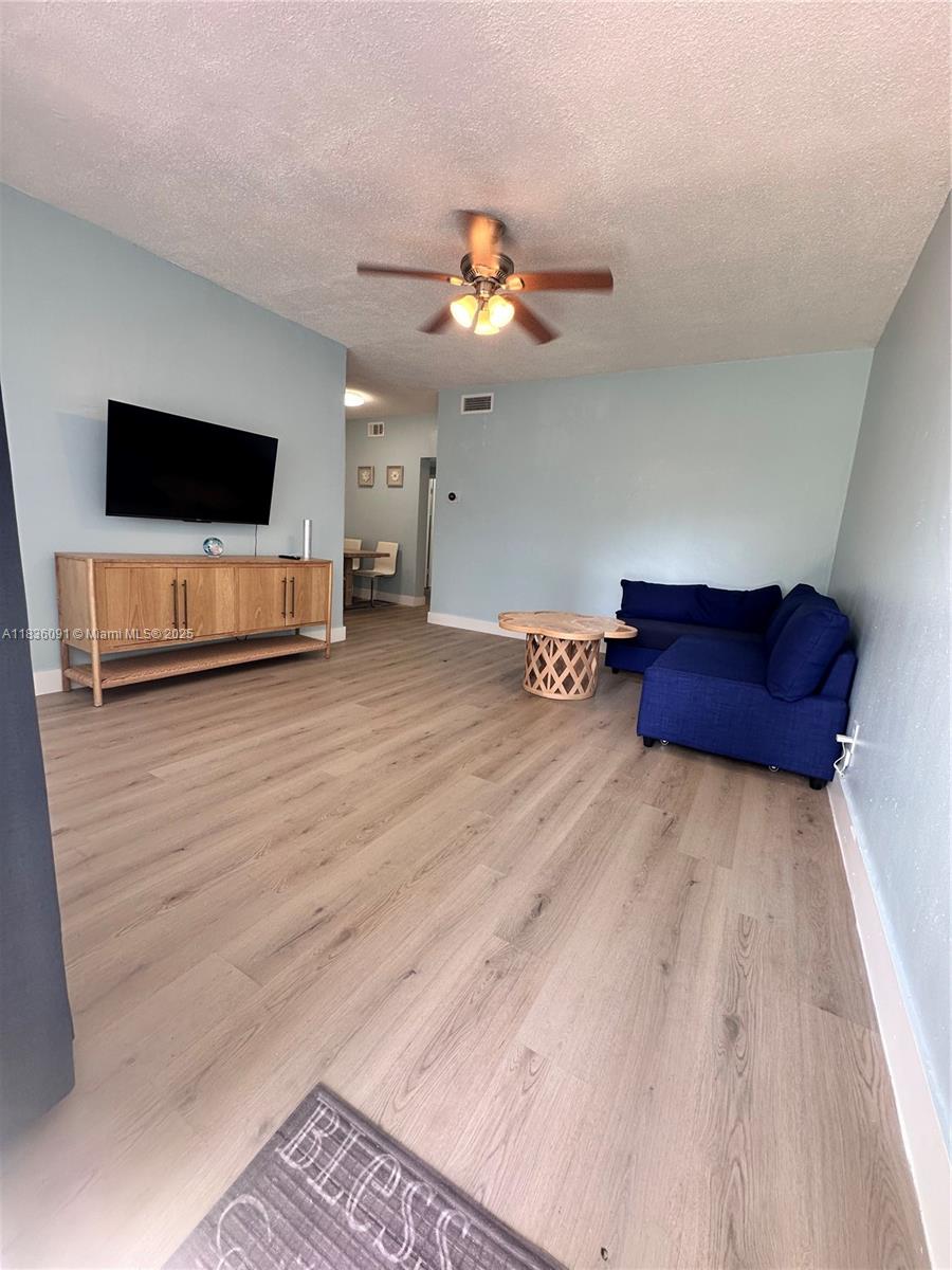 2200 South Ocean Drive, Unit N110 Hollywood, FL 33019 - Photo 6 of 21 a living room with furniture and a flat screen tv