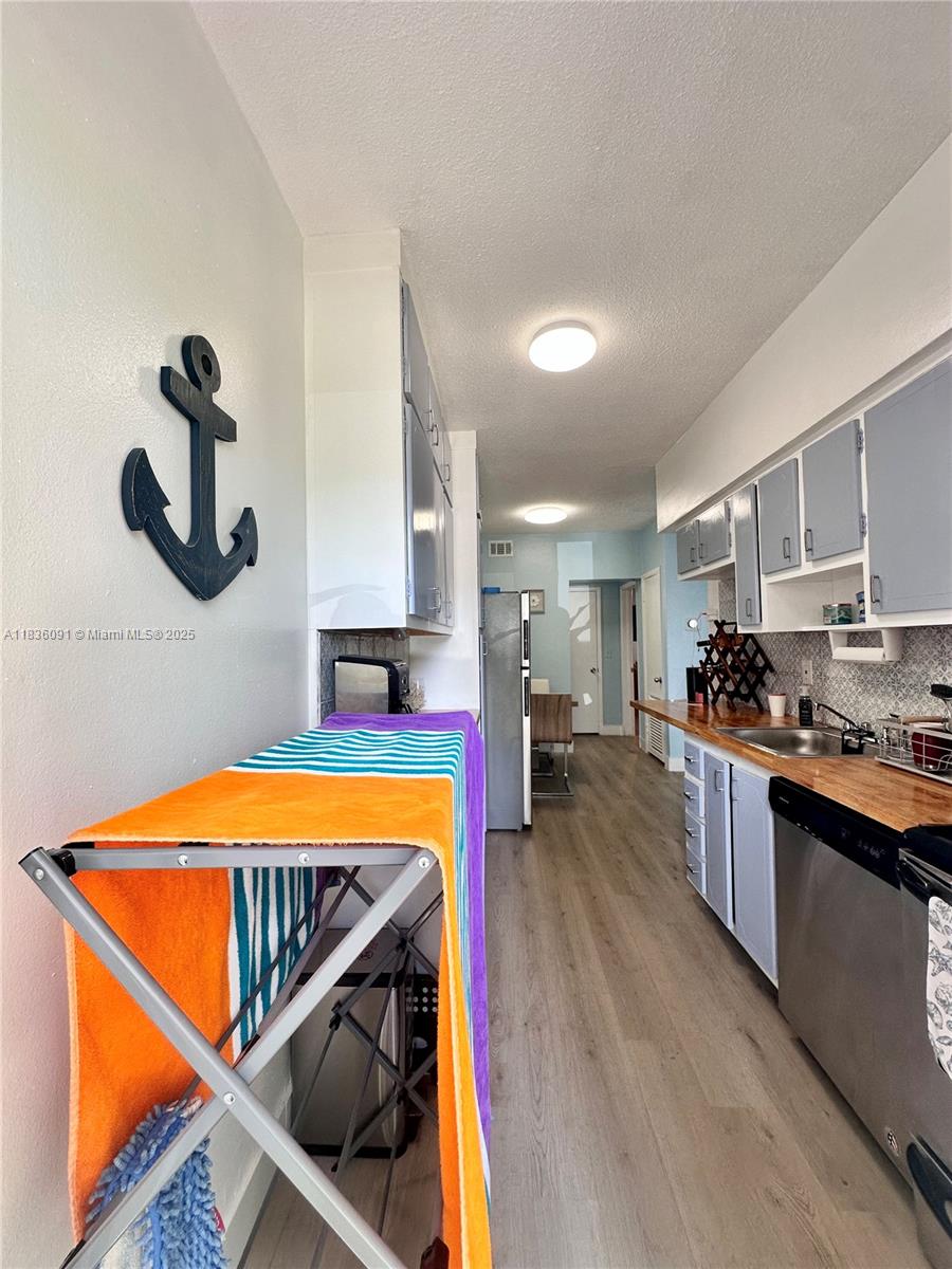 2200 South Ocean Drive, Unit N110 Hollywood, FL 33019 - Photo 9 of 21 a kitchen with stainless steel appliances granite countertop a sink and a stove