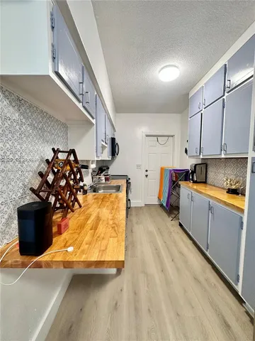 a kitchen with a sink and a stove top oven