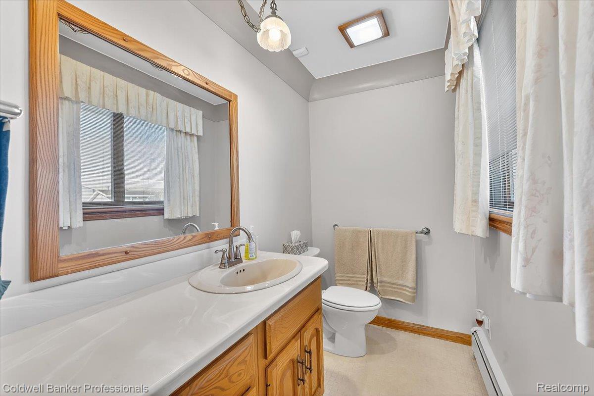 7410 Wilson Road Montrose, MI 48457 - Photo 22 of 38 Bathroom with vanity and baseboard heating