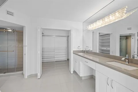 a bathroom with a granite countertop sink mirror and double