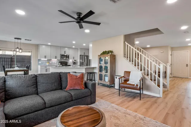 a living room with furniture and kitchen view