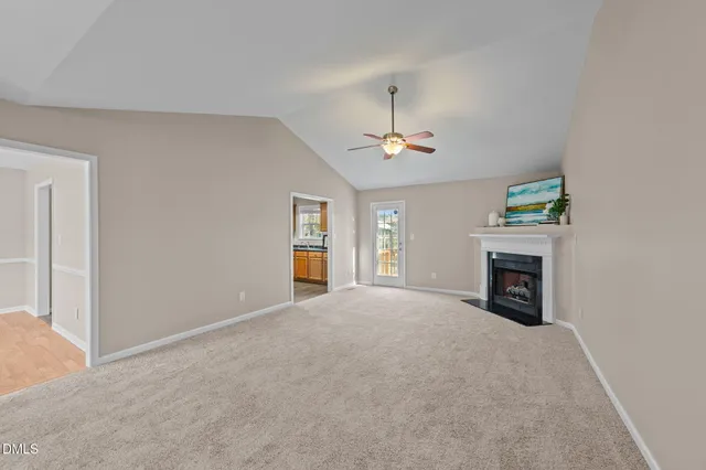 a view of an empty room with a fireplace