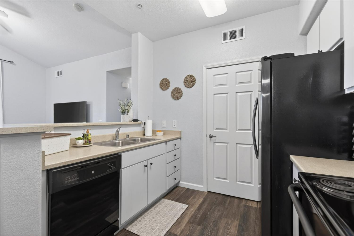 1251 Whitney Ranch Parkway, Unit 1231 Rocklin, CA 95765 - Photo 13 of 44 a kitchen with stainless steel appliances a refrigerator sink and stove