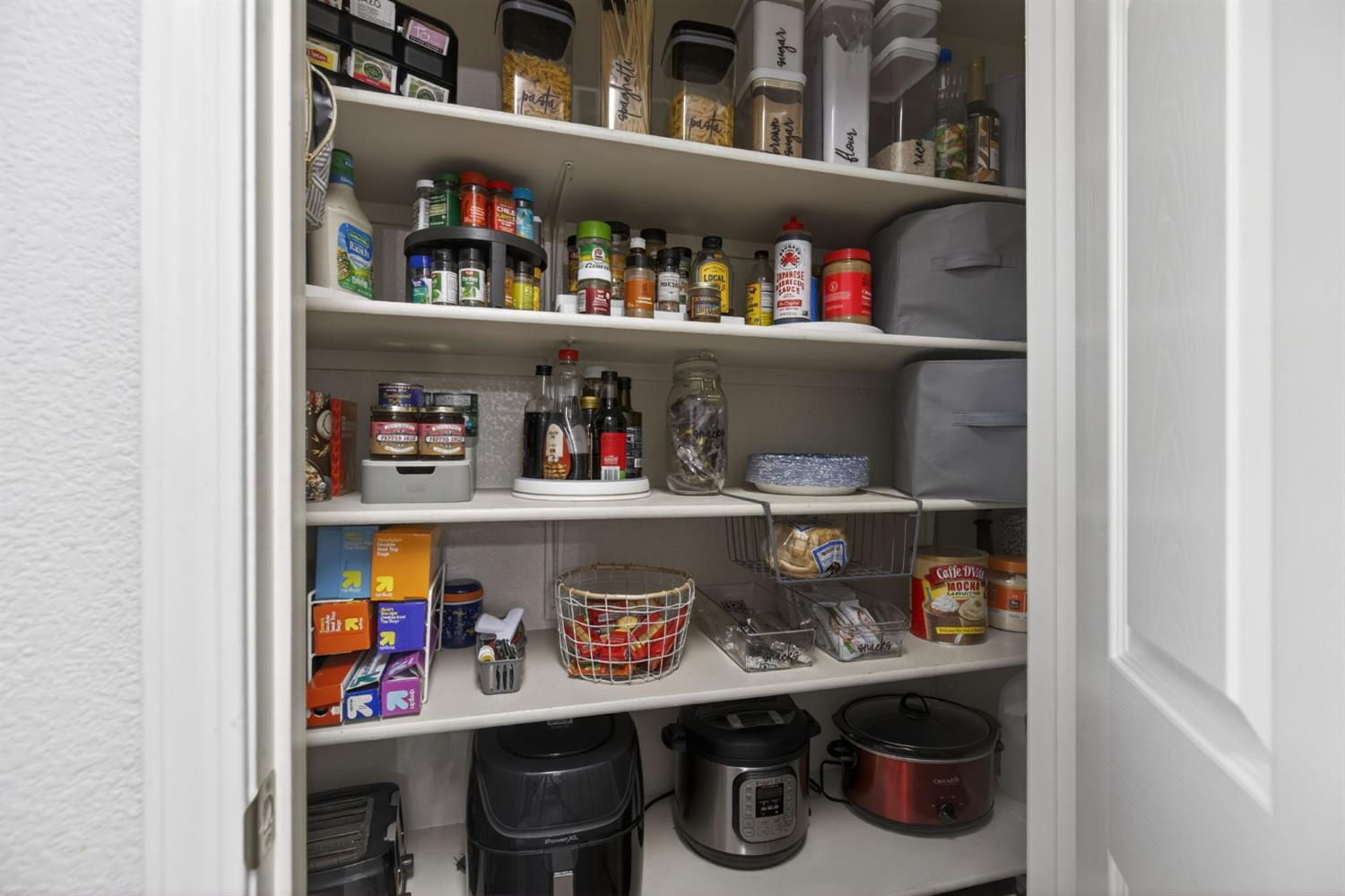 1251 Whitney Ranch Parkway, Unit 1231 Rocklin, CA 95765 - Photo 14 of 44 a room with food on a shelf and a shelf