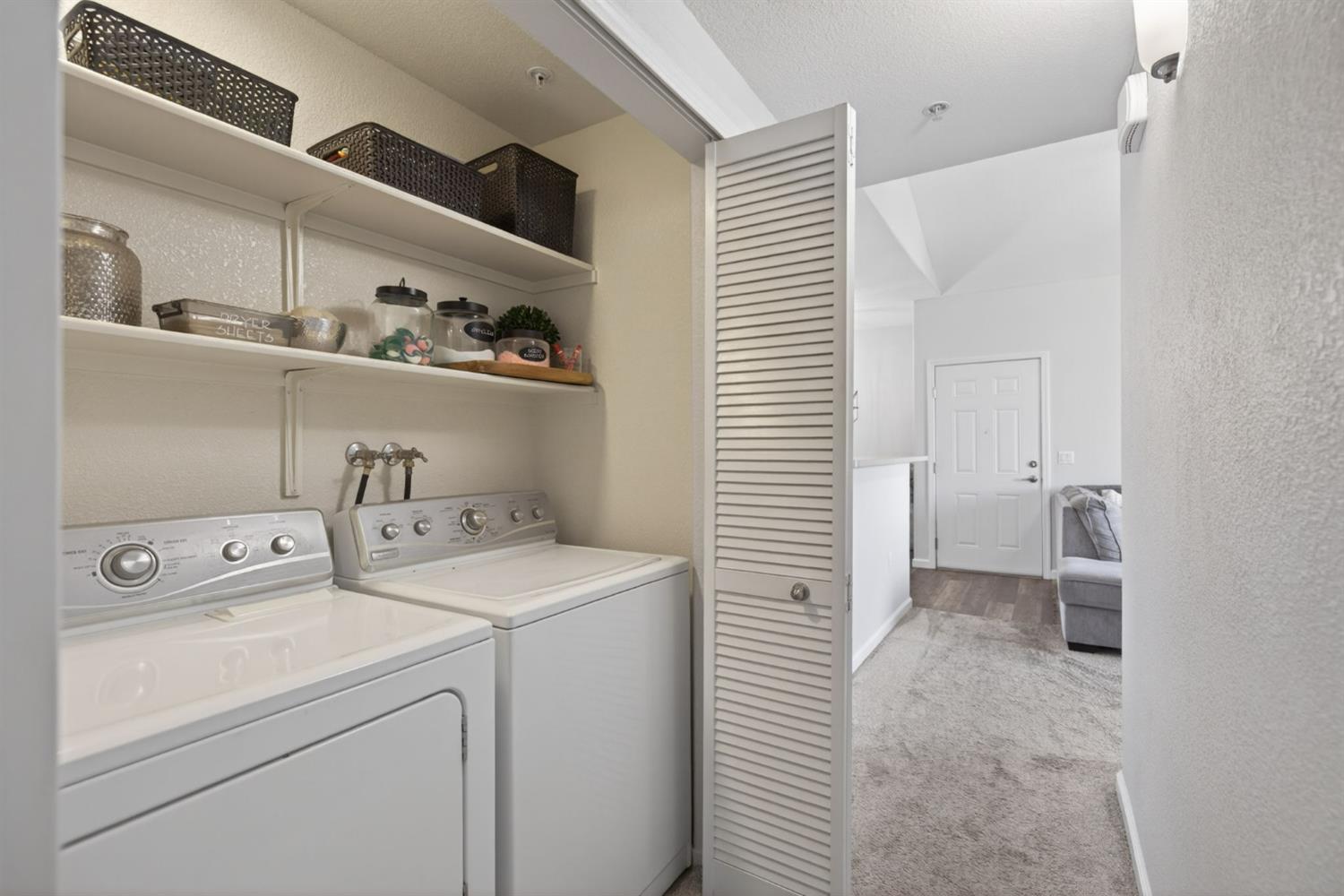 1251 Whitney Ranch Parkway, Unit 1231 Rocklin, CA 95765 - Photo 21 of 44 a view of washer and dryer with kitchen in the background