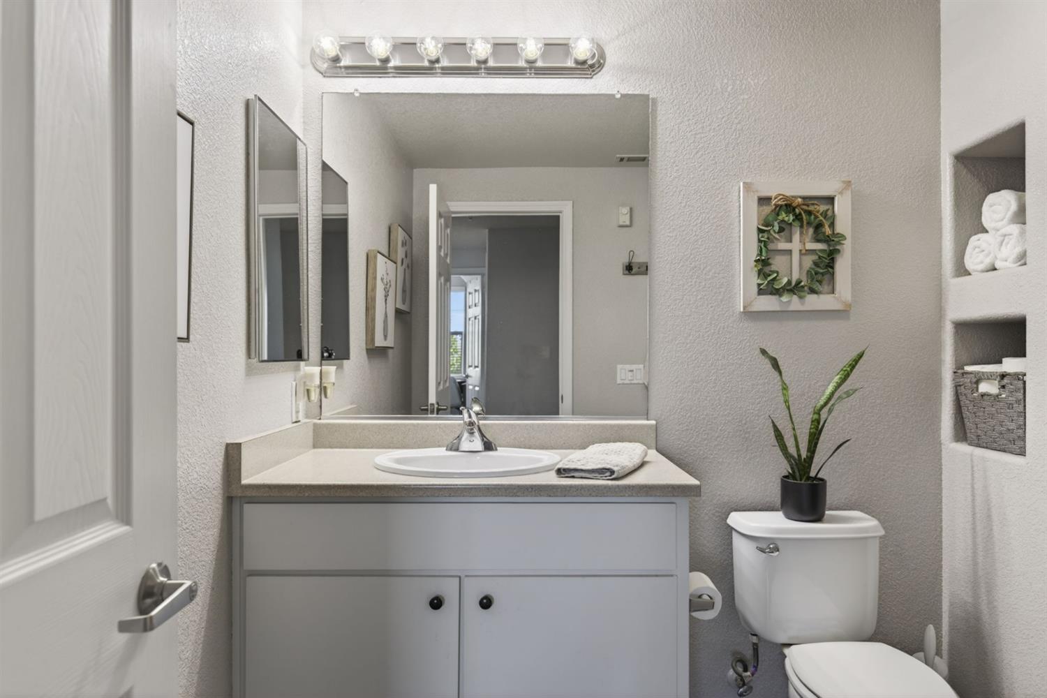 1251 Whitney Ranch Parkway, Unit 1231 Rocklin, CA 95765 - Photo 26 of 44 a bathroom with a toilet sink and mirror