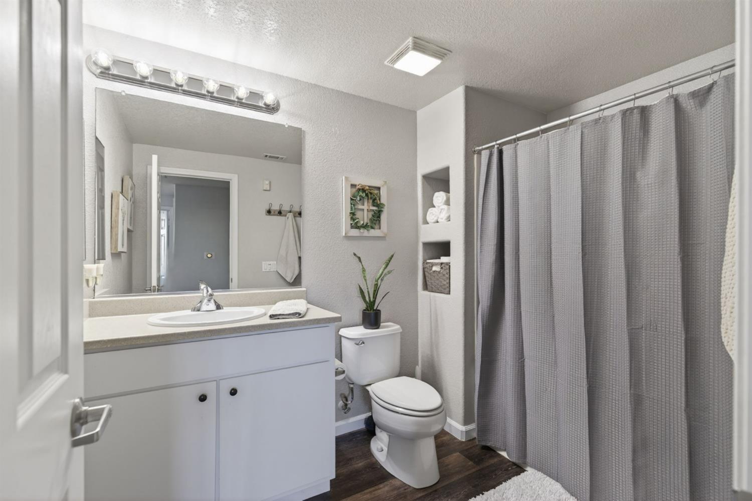 1251 Whitney Ranch Parkway, Unit 1231 Rocklin, CA 95765 - Photo 27 of 44 a bathroom with a toilet a sink and a mirror