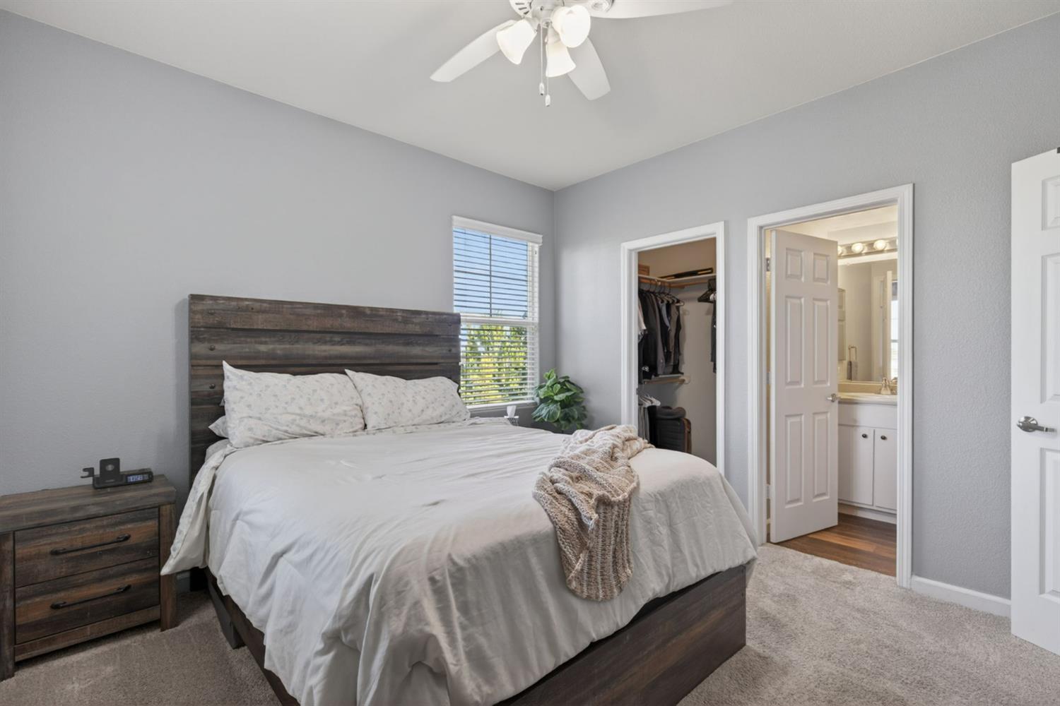 1251 Whitney Ranch Parkway, Unit 1231 Rocklin, CA 95765 - Photo 29 of 44 a bedroom with a large bed and a chandelier