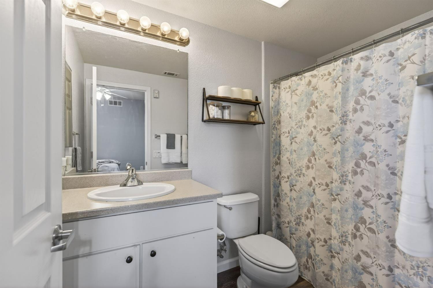 1251 Whitney Ranch Parkway, Unit 1231 Rocklin, CA 95765 - Photo 32 of 44 a bathroom with a sink a toilet and shower curtain