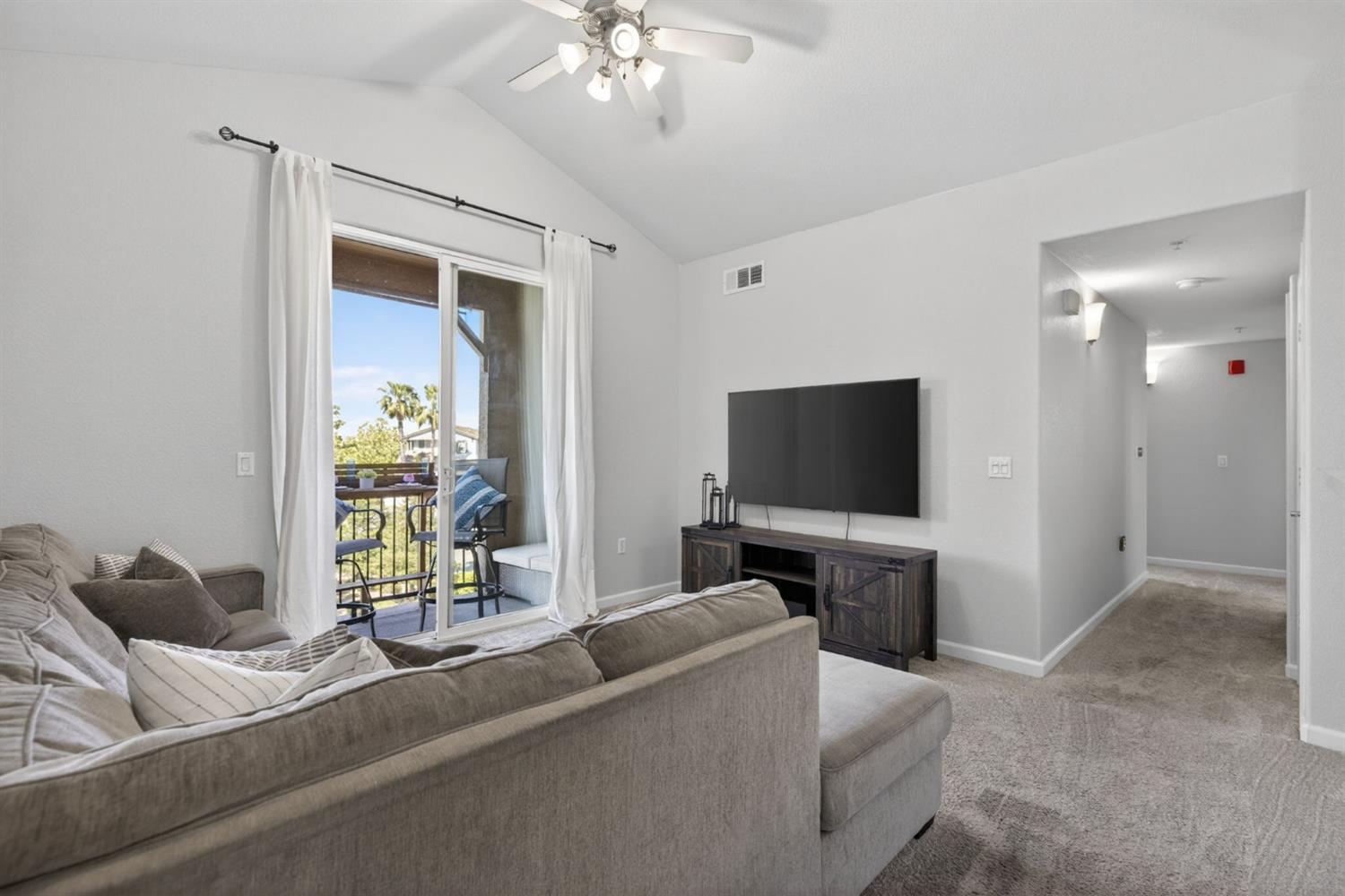 1251 Whitney Ranch Parkway, Unit 1231 Rocklin, CA 95765 - Photo 6 of 44 a living room with furniture and a flat screen tv