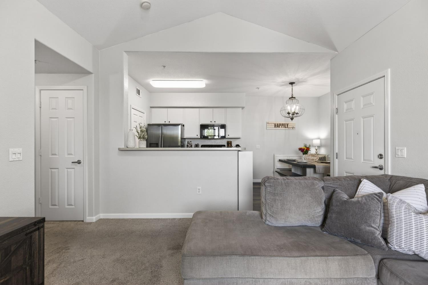 1251 Whitney Ranch Parkway, Unit 1231 Rocklin, CA 95765 - Photo 7 of 44 a living room with furniture and kitchen view
