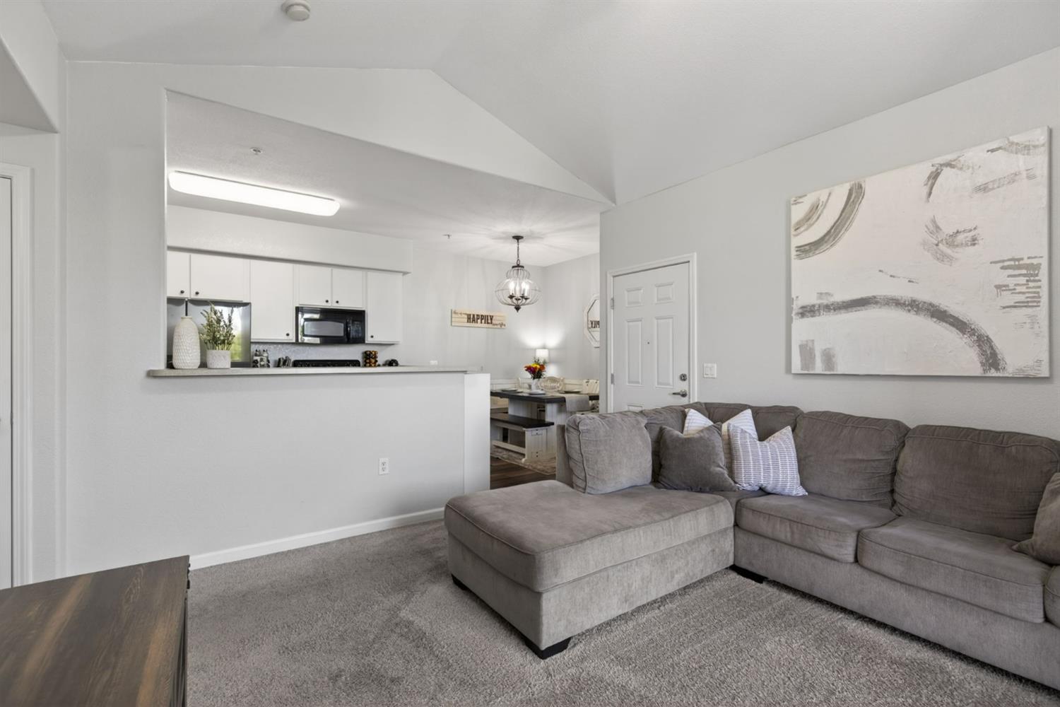 1251 Whitney Ranch Parkway, Unit 1231 Rocklin, CA 95765 - Photo 8 of 44 a living room with furniture and kitchen view