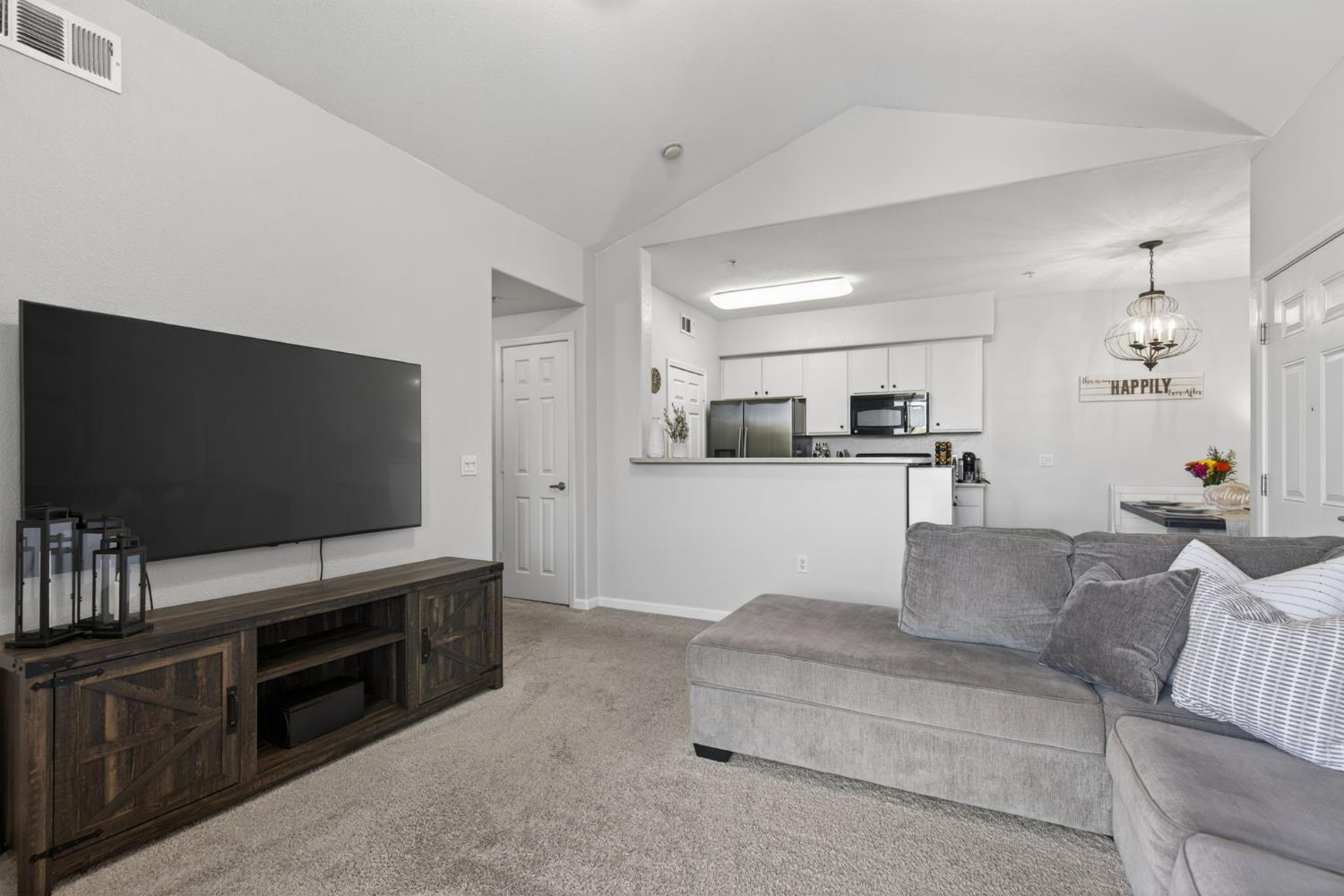 1251 Whitney Ranch Parkway, Unit 1231 Rocklin, CA 95765 - Photo 10 of 44 a living room with furniture and a flat screen tv