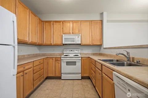 a kitchen with a sink and refrigerator