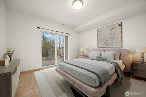 a bedroom with a bed and a large window