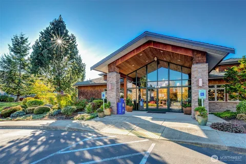 a living room with furniture a fireplace and a potted plant
