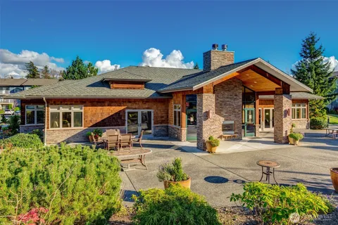 a large dining space with furniture a kitchen and chandelier