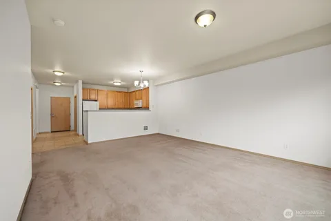 an empty room with a bathroom and a mirror