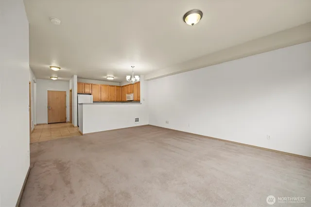 an empty room with a bathroom and a mirror