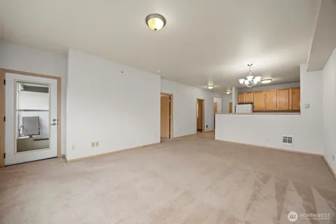 a kitchen with stainless steel appliances granite countertop a sink and dishwasher a stove top oven with white cabinets