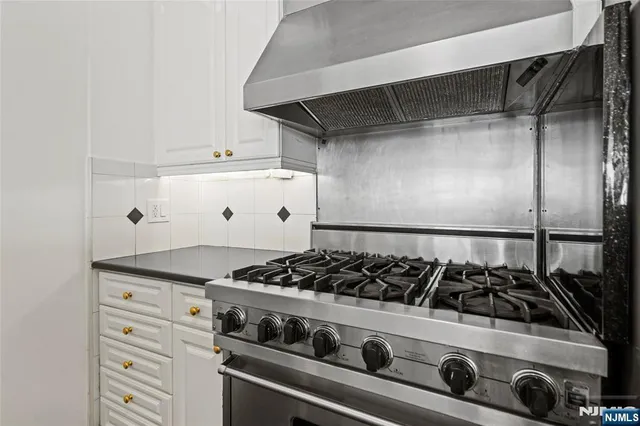 a kitchen with a sink and a stove top oven
